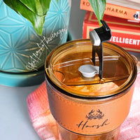 tumbler with leather grip and glass straw