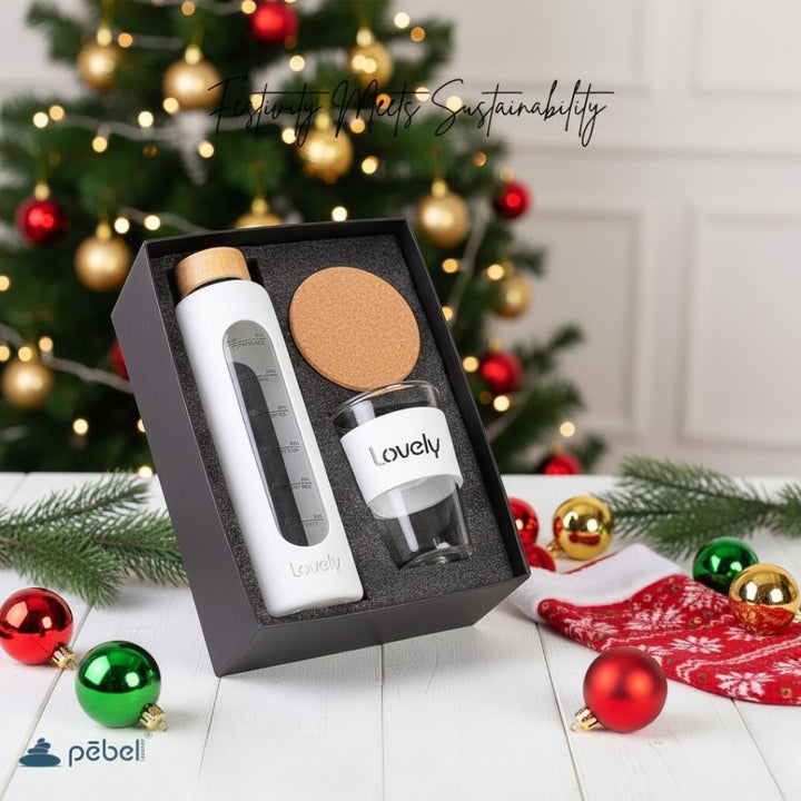 Gift set with water bottle and glass in a box, Christmas tree in the background