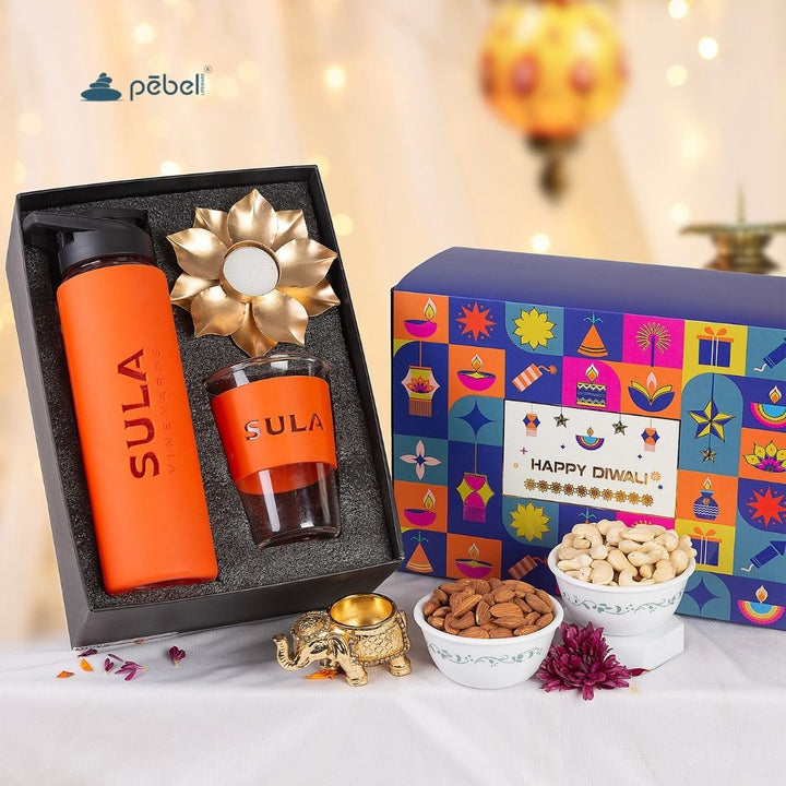 Gift set with eco-friendly branded items and Diwali-themed packaging on a decorative background.