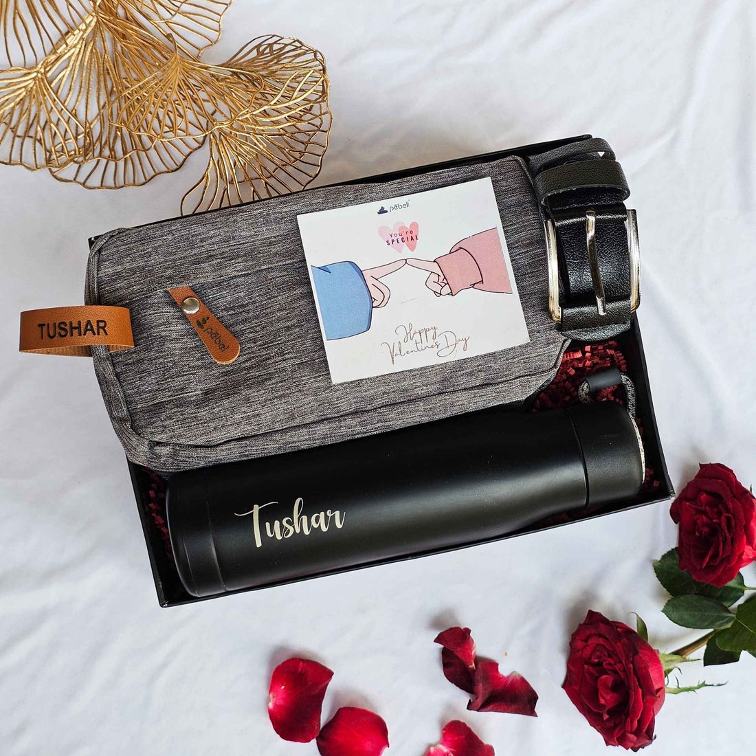 Premium gift box with personalized bottle, shaving pouch, and belt.
